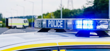Close up of police vehicle with blue flashing lights